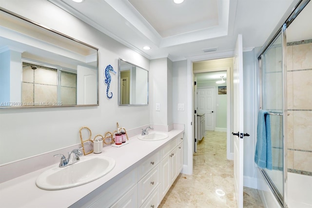 full bathroom with double vanity, a tray ceiling, a sink, and recessed lighting