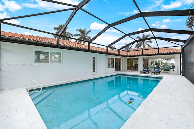 pool with a lanai and a patio area