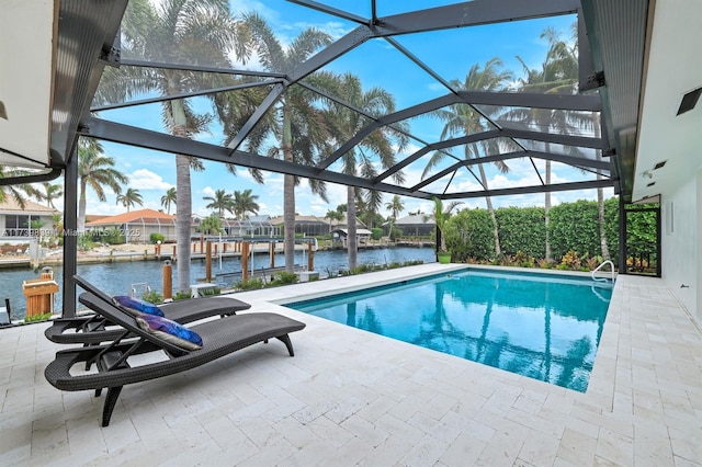 outdoor pool featuring a dock, a patio area, glass enclosure, and a water view