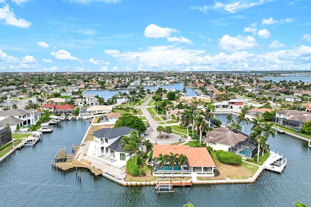 bird's eye view featuring a water view and a residential view