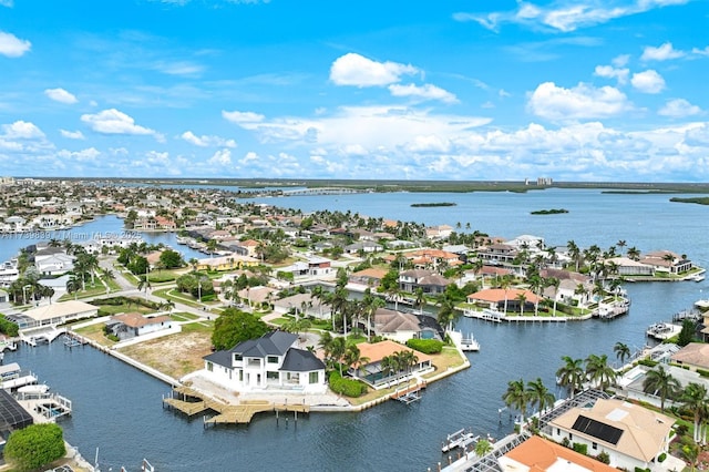 drone / aerial view with a water view and a residential view