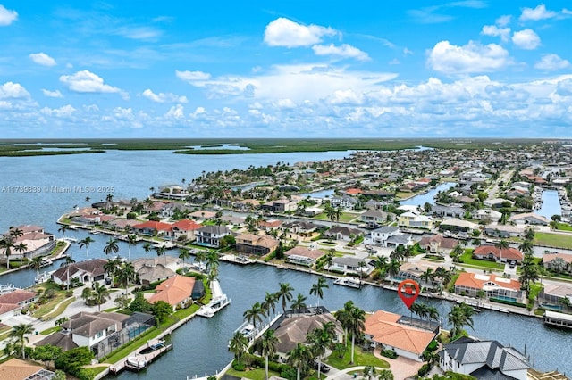 drone / aerial view with a water view and a residential view