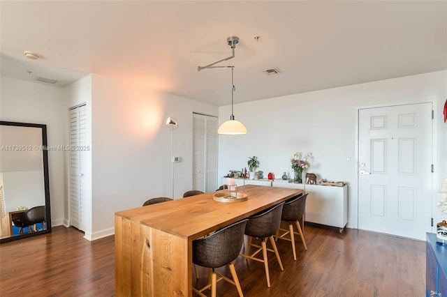 dining room with dark hardwood / wood-style flooring