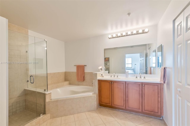 bathroom with tile patterned flooring, vanity, and separate shower and tub