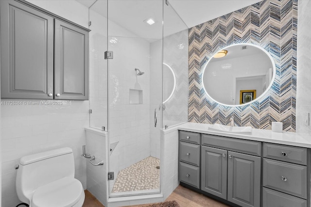 bathroom featuring vanity, tile walls, an enclosed shower, and toilet