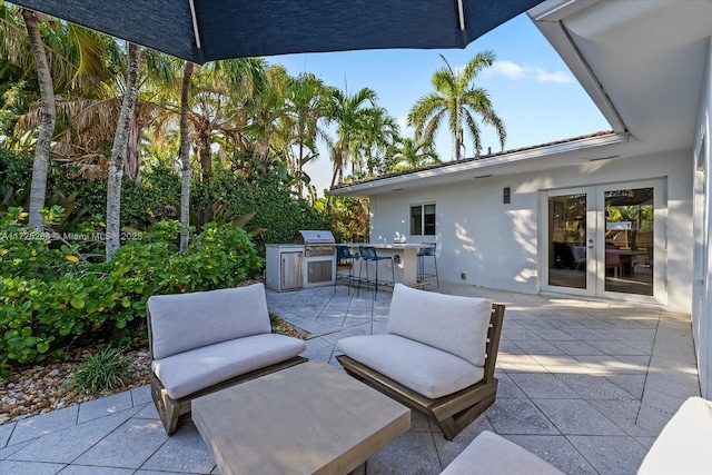 view of patio with a bar, area for grilling, grilling area, and french doors