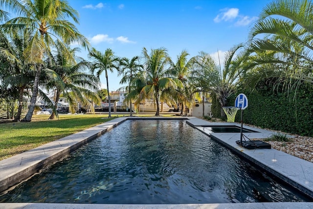 view of pool with a yard