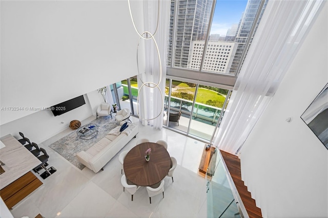 living room with a towering ceiling and plenty of natural light