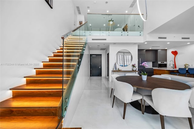 dining area with a towering ceiling