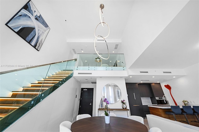 dining space featuring a towering ceiling