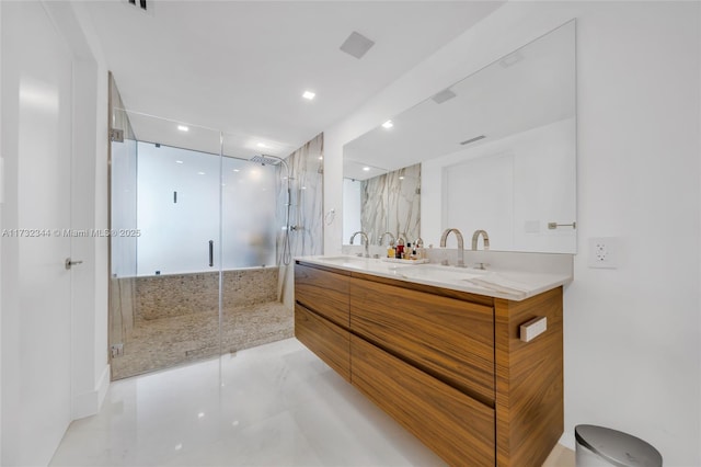 bathroom featuring an enclosed shower and vanity