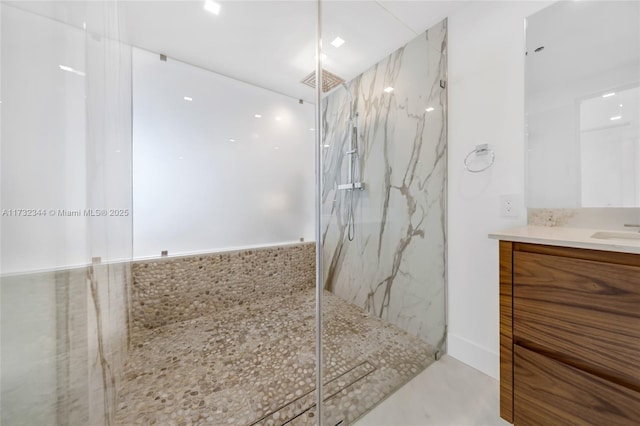 bathroom featuring vanity and a tile shower