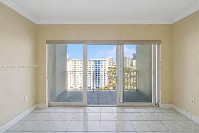500 Bayview Dr Unit 1419, Sunny Isles Beach, FL 33160 - unfurnished room featuring tile patterned flooring, a city view, baseboards, and ornamental molding
