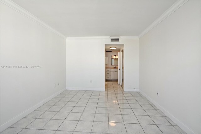 tiled spare room with ornamental molding