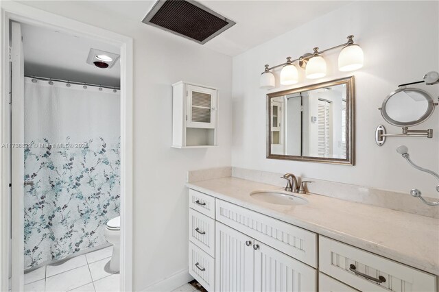 bathroom featuring tile patterned floors, vanity, and toilet