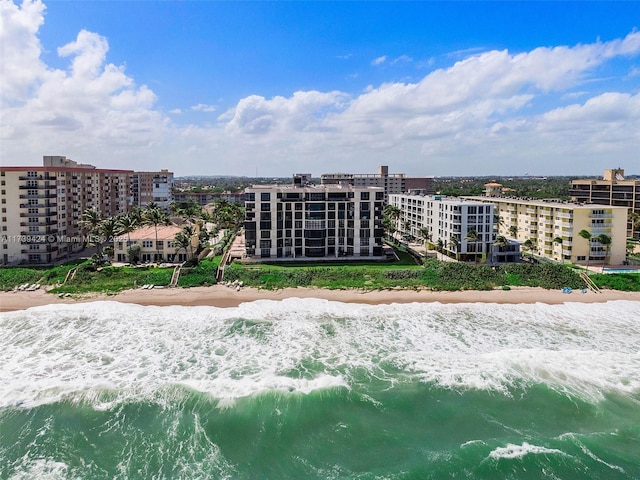 birds eye view of property with a view of the beach and a water view