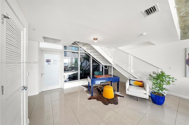 interior space featuring light tile patterned floors and expansive windows