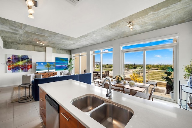 kitchen with dishwasher, sink, and light tile patterned floors