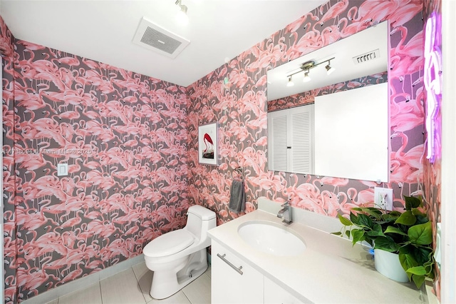 bathroom featuring vanity, tile patterned floors, and toilet