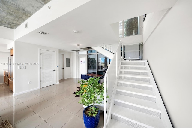 staircase with tile patterned floors