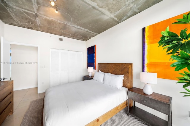 bedroom featuring a closet and light tile patterned floors