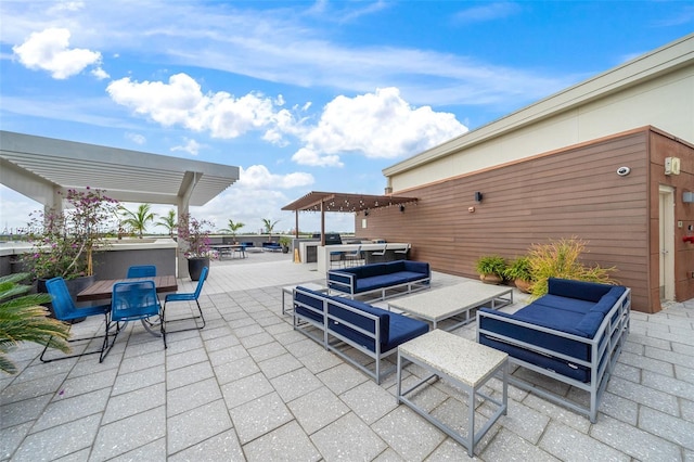 view of patio featuring an outdoor living space and a pergola