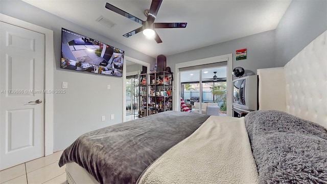 tiled bedroom with access to outside and ceiling fan