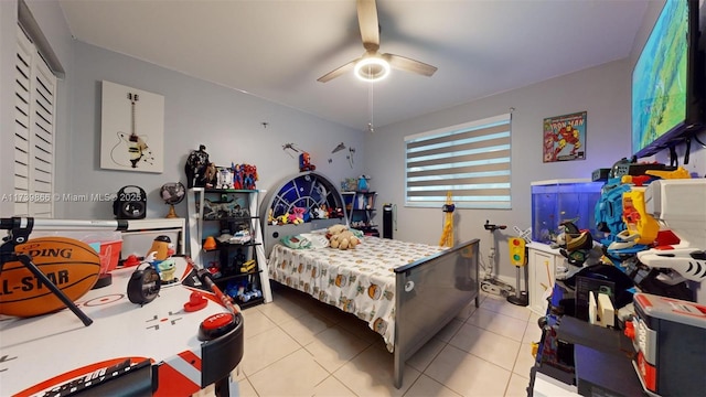 tiled bedroom with ceiling fan