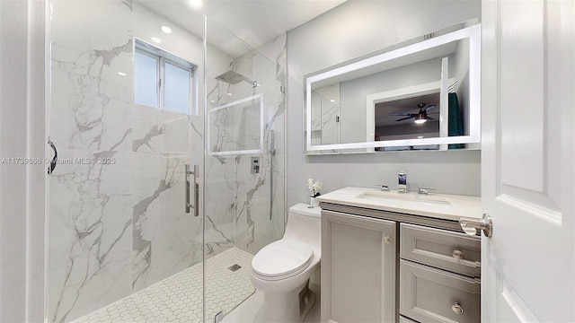 bathroom with vanity, ceiling fan, toilet, and walk in shower