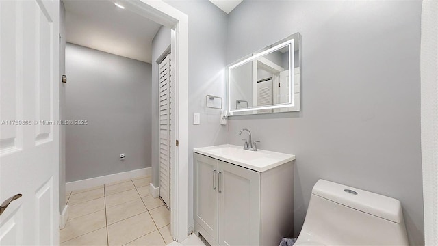 bathroom with vanity, tile patterned flooring, and toilet