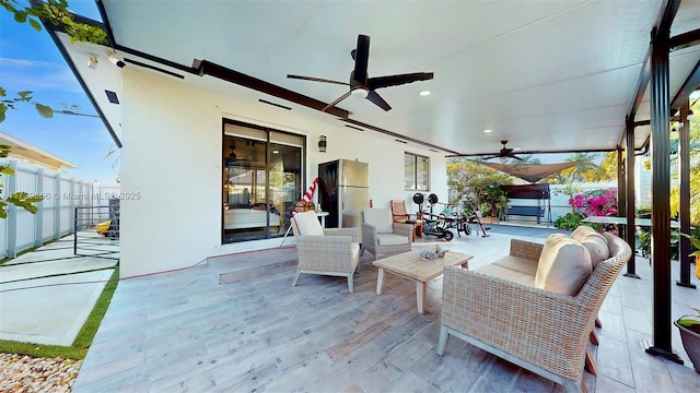 view of patio with ceiling fan and an outdoor living space