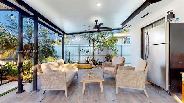 sunroom with ceiling fan