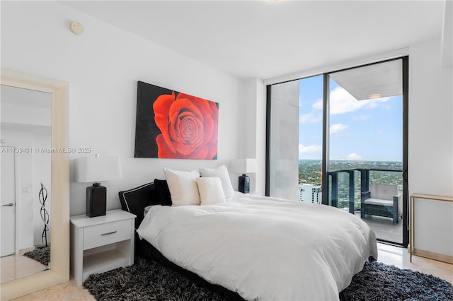 bedroom featuring a wall of windows and access to outside