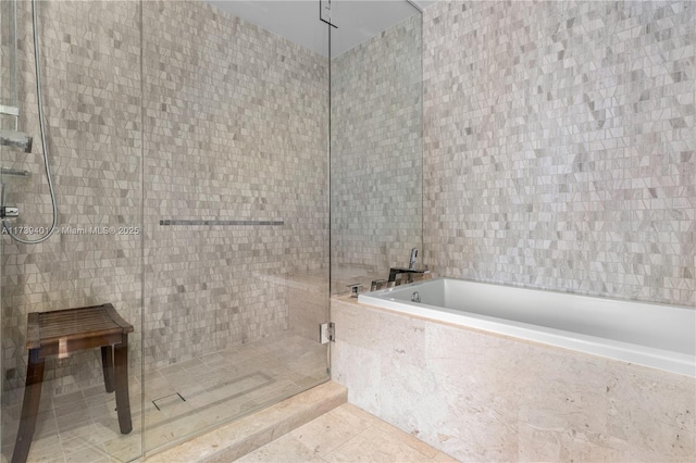 bathroom featuring tile patterned floors and shower with separate bathtub