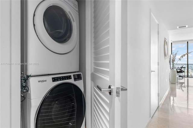 washroom with stacked washer / drying machine