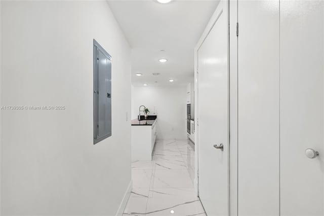 hallway with sink and electric panel