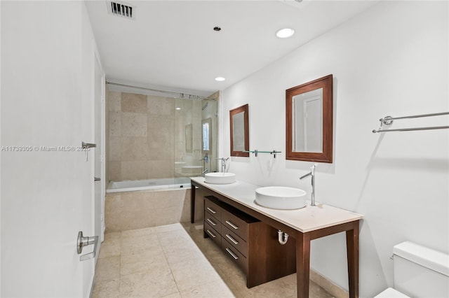 full bathroom with vanity, tile patterned floors, toilet, and tiled shower / bath