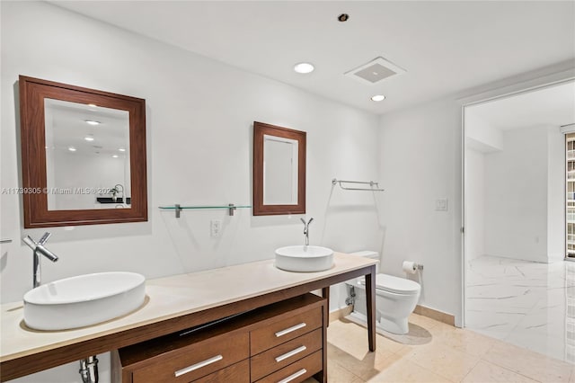 bathroom with vanity and toilet