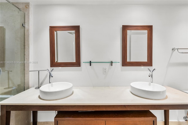 bathroom featuring a shower with door and vanity