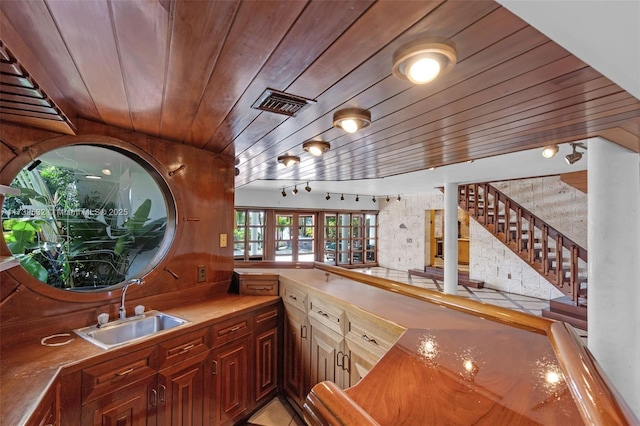 bar featuring track lighting, sink, and wooden ceiling