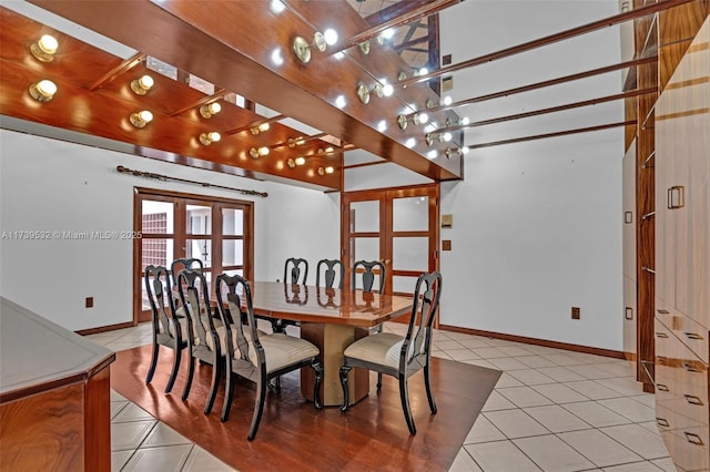 tiled dining space featuring french doors