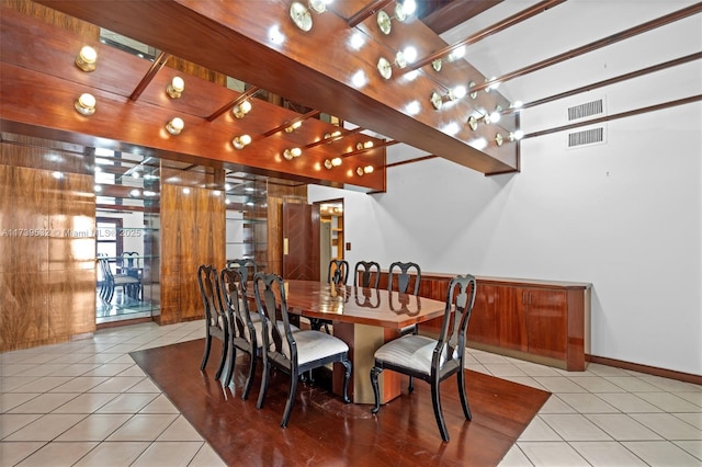 dining space featuring light tile patterned flooring and track lighting