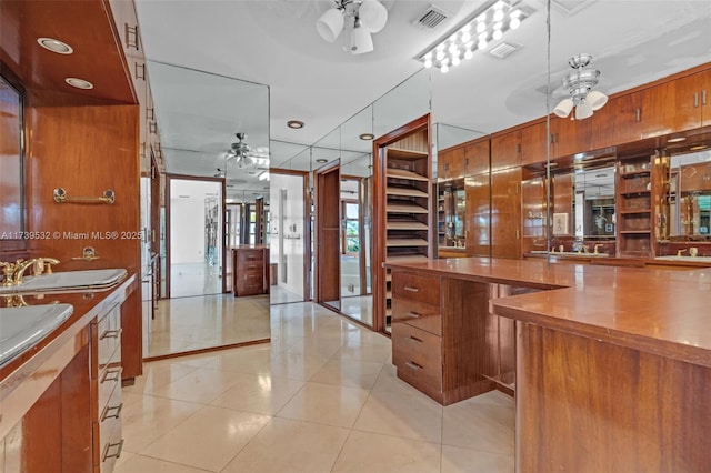 kitchen featuring sink, light tile patterned floors, and ceiling fan