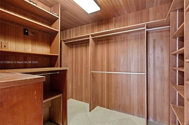 walk in closet featuring light tile patterned flooring