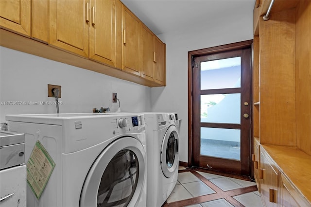 laundry area with cabinets, separate washer and dryer, and light tile patterned floors