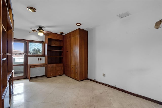 interior space with ceiling fan