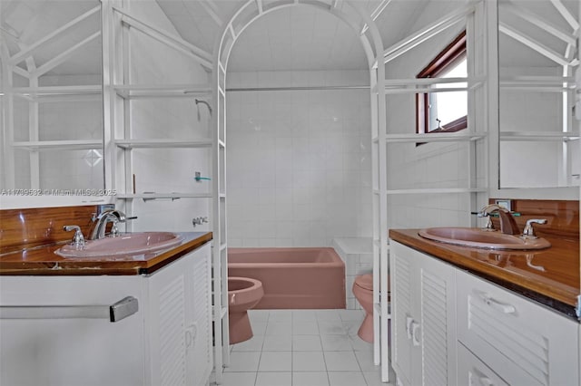 full bathroom featuring tile patterned flooring, vanity, tiled shower / bath combo, and toilet