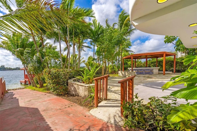 view of community with a gazebo and a water view