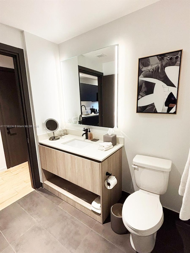 bathroom with vanity, tile patterned floors, and toilet