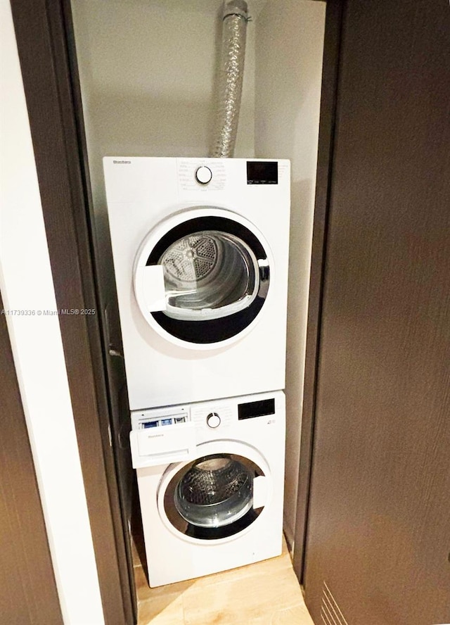 laundry area featuring stacked washer / dryer